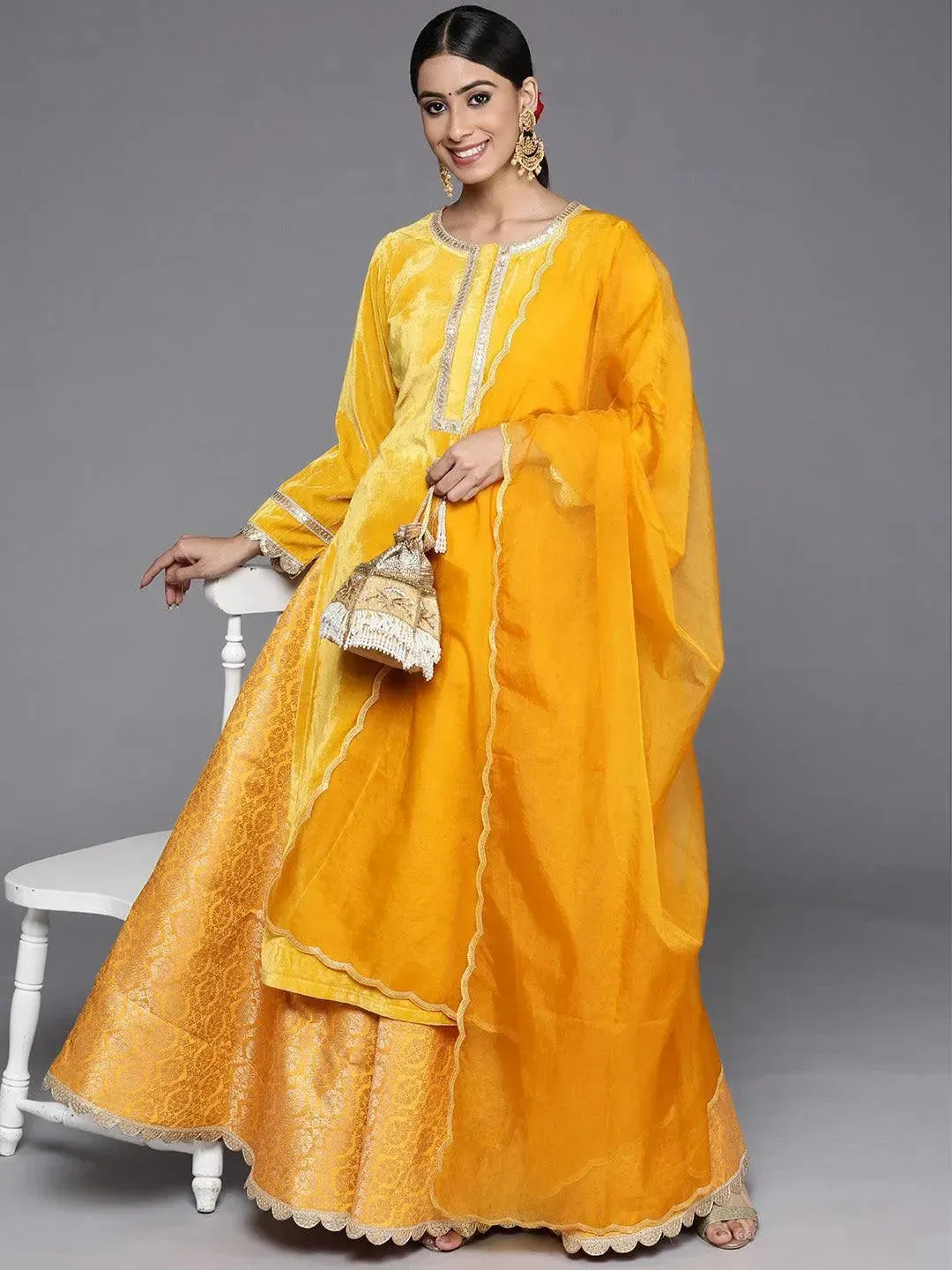 Yellow Yoke Design Velvet Straight Kurta With Skirt & Dupatta